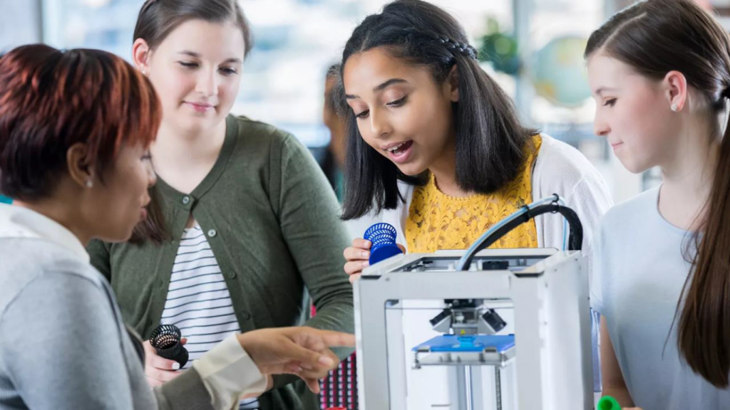 Teacher guiding students during a hands-on STEAM activity
