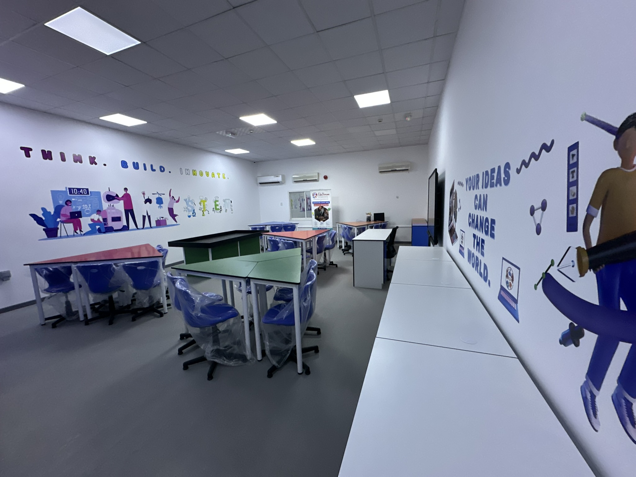 A completed EduStream STEAM and innovation lab in a UAE school, with collaborative workstations and branded wall graphics