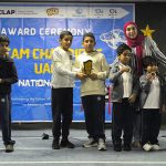 Students on stage holding trophies at the STEAM Champions UAE national award ceremony