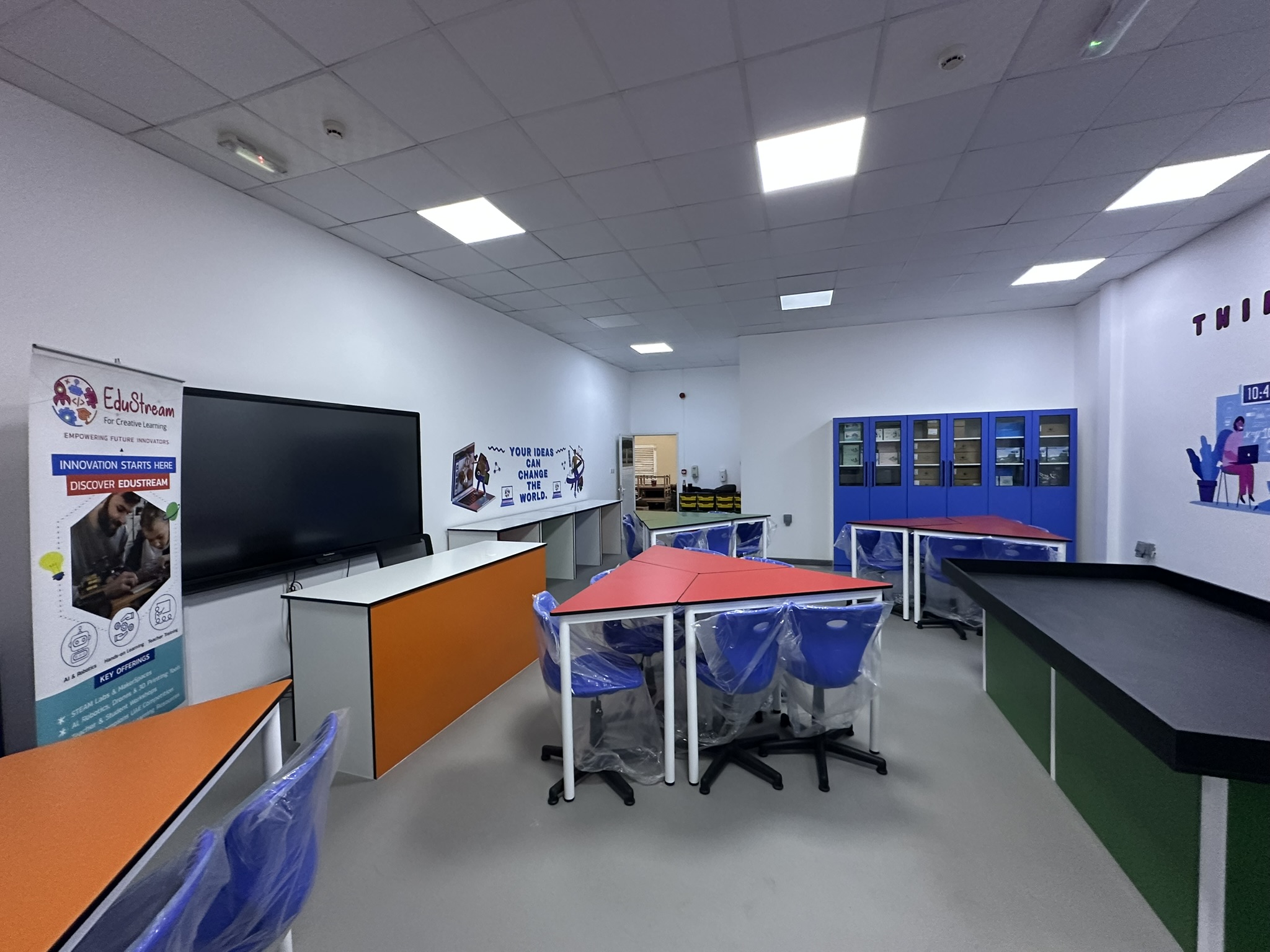 A newly completed EduStream AI and robotics lab in a UAE school with collaborative workstations, storage and an interactive display