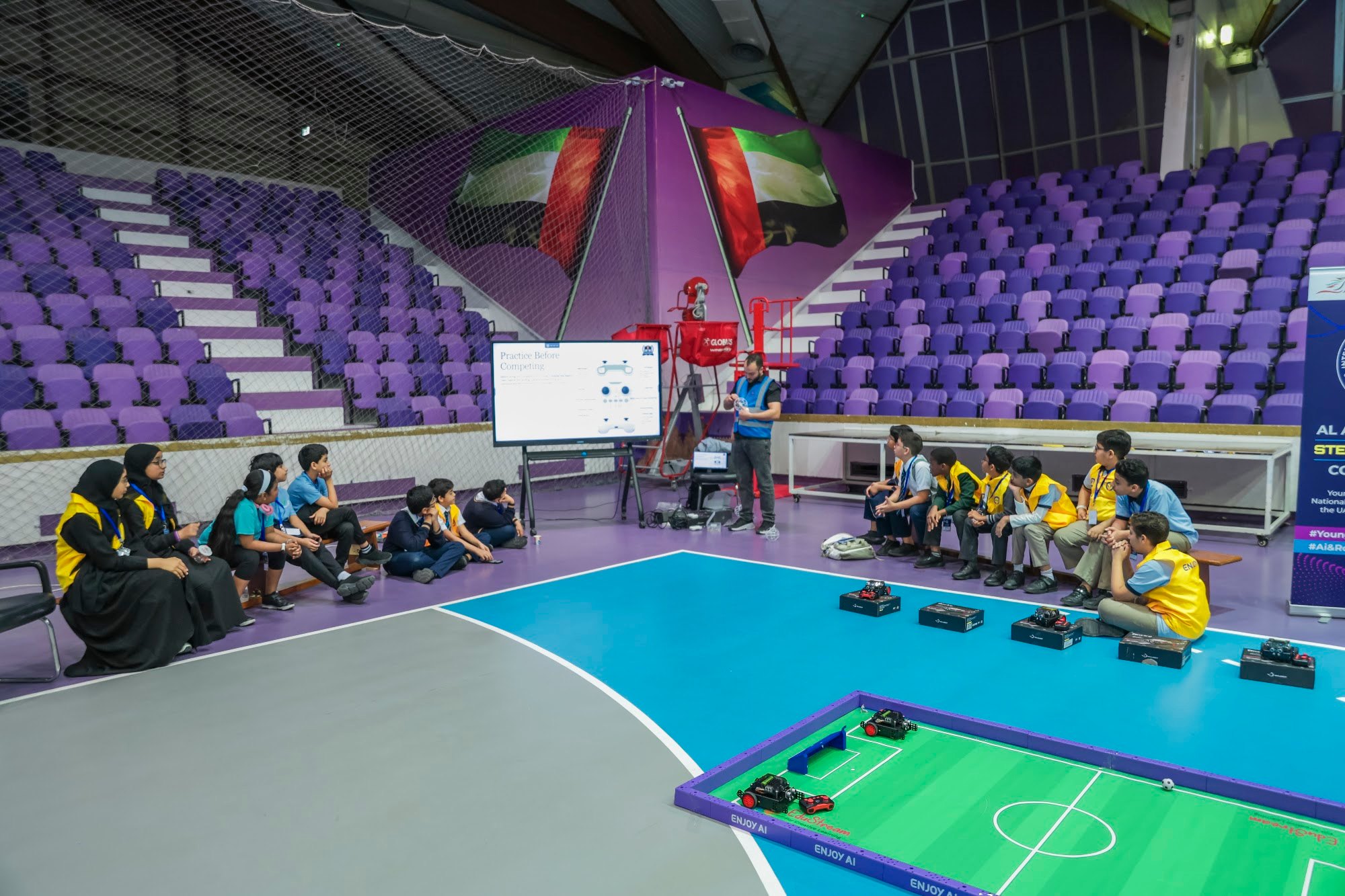 Student teams seated around a robotics competition arena during an EduStream STEAM Champions event