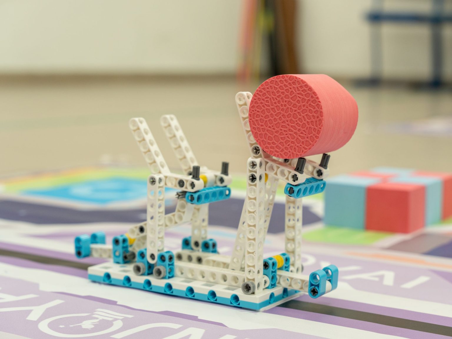 Close-up of a student-built robot model on a competition mat